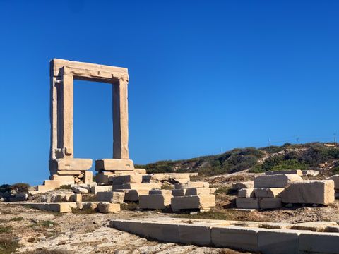 The Portara's marble doorway against a deep blue sky